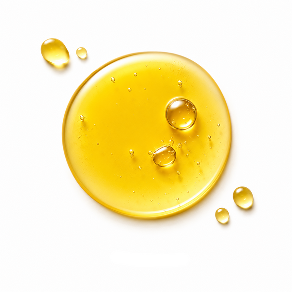 A glossy droplet of golden yellow Vitamin E oil on a white background, with the text 'VITAMIN E' printed below.