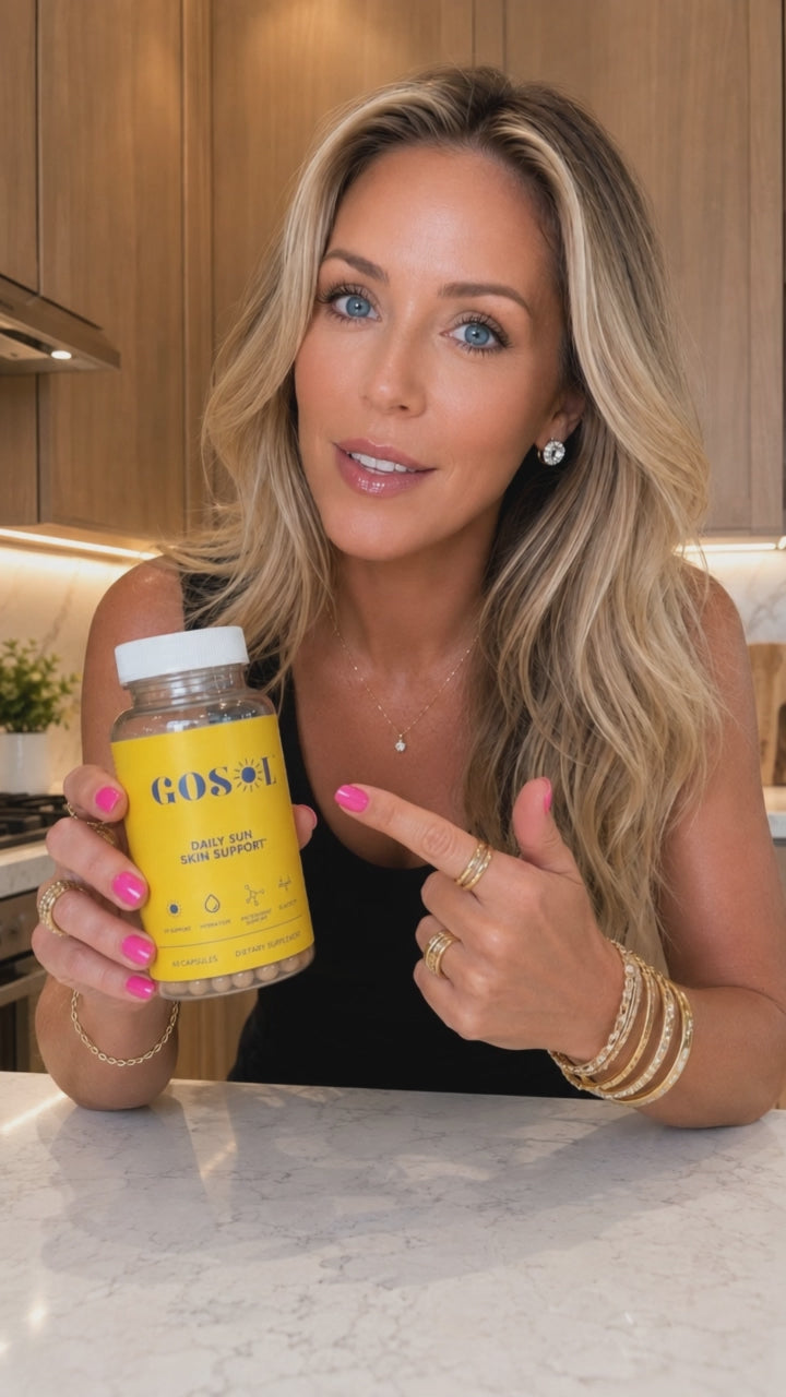 A GoSol Daily routine video of a woman in a kitchen holding and presenting a bottle of GoSol Daily skin support supplements formulated with Polypodium leucotomos, astaxanthin, vitamin C and vitamin E to support skin health and antioxidant defenses.*